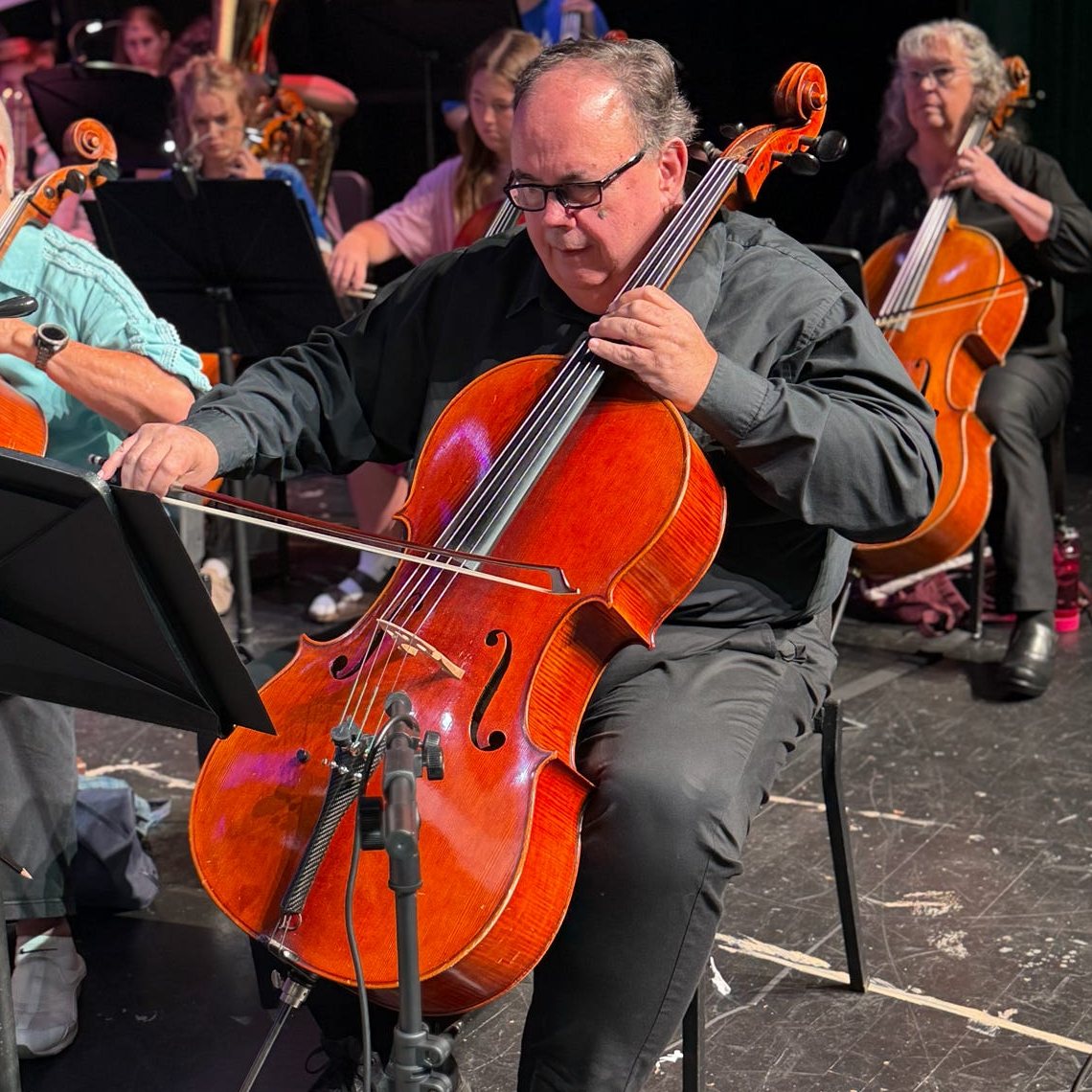Cellists playing during rehearsal
